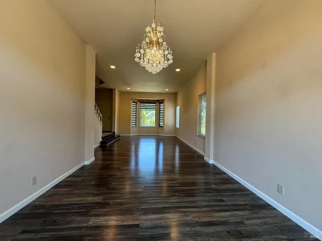 a view of an entryway with wooden floor