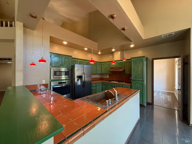 a room with table tennis pool table and glass door
