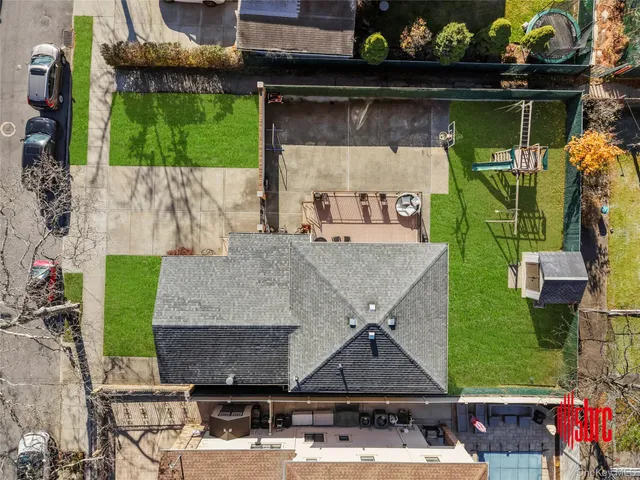 a view of a backyard with potted plants and large tree