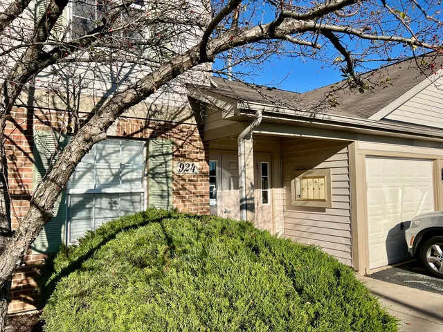 a view of a house with a large window and a yard
