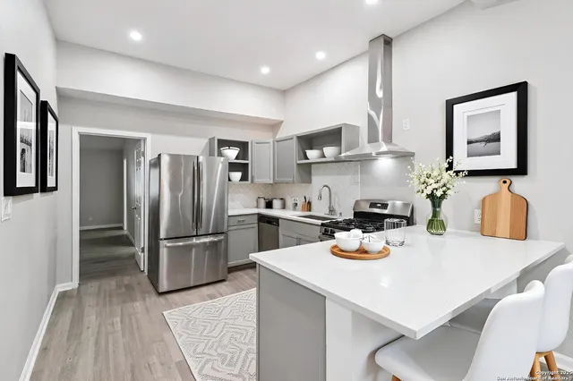 a kitchen with a sink stove top oven and cabinets