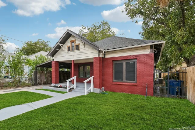 a view of a house with a yard and sitting area