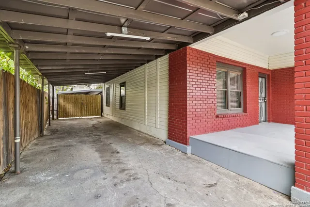 a view of a porch with wooden floor and front door