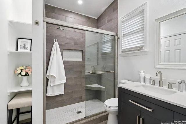 a kitchen with a refrigerator and a stove top oven