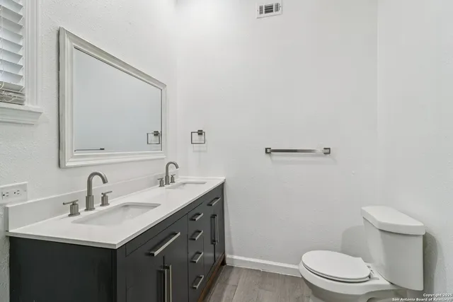 a white toilet sitting next to a shower