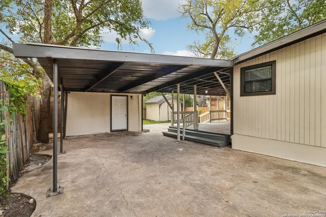 a view of house with backyard outdoor seating and deck