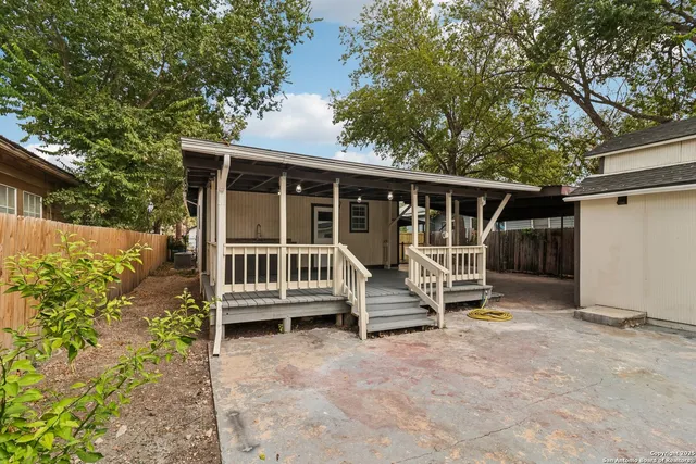 a view of a house with backyard porch and sitting area