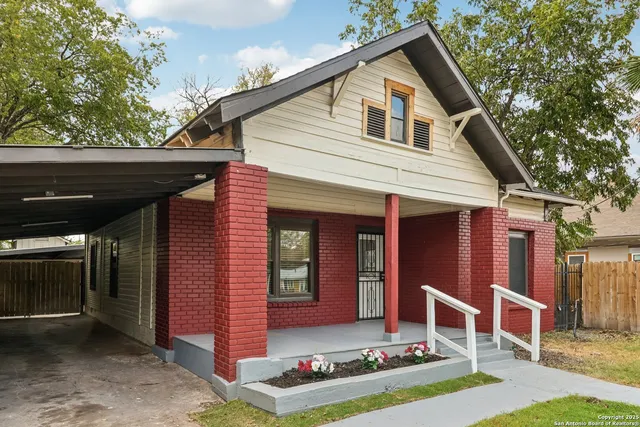 a living room with furniture potted plant and a flat screen tv