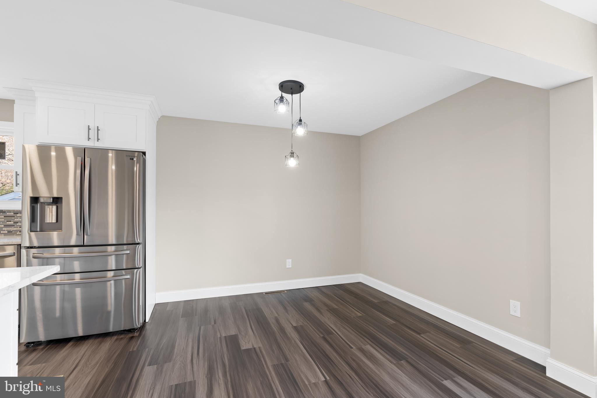628 South Brownleaf Road Newark, DE 19713 - Photo 13 of 36 a kitchen with a refrigerator and wooden floor