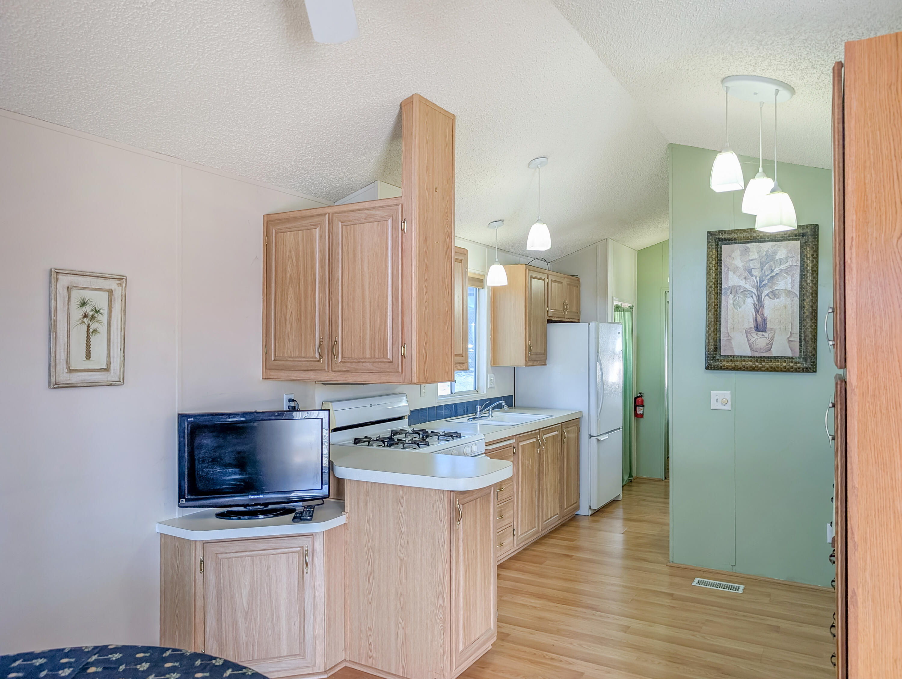 70200 Dillon Road, Unit 422 Desert Hot Springs, CA 92241 - Photo 13 of 25 a kitchen with stainless steel appliances a stove a sink and a microwave