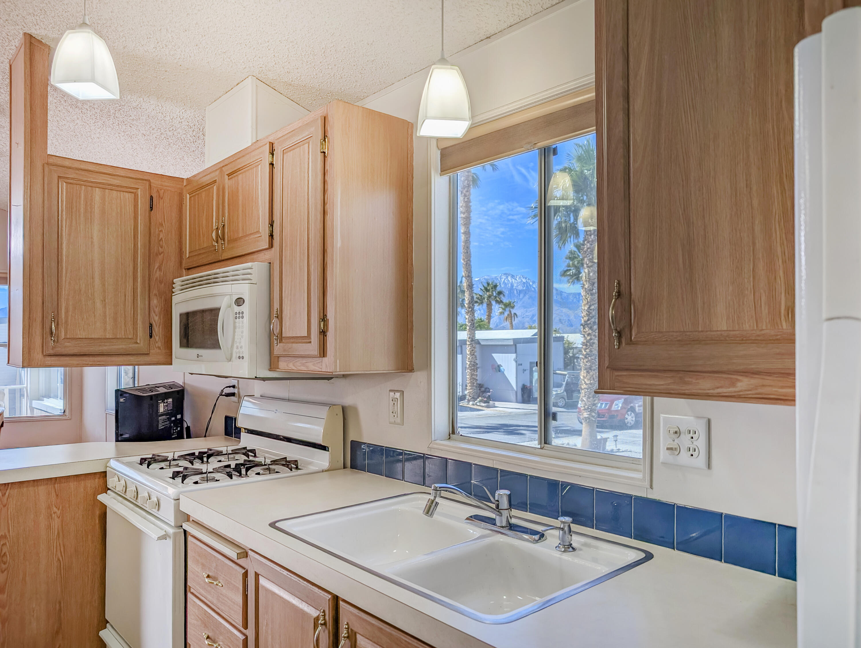 70200 Dillon Road, Unit 422 Desert Hot Springs, CA 92241 - Photo 16 of 25 a kitchen with a sink stove and cabinets