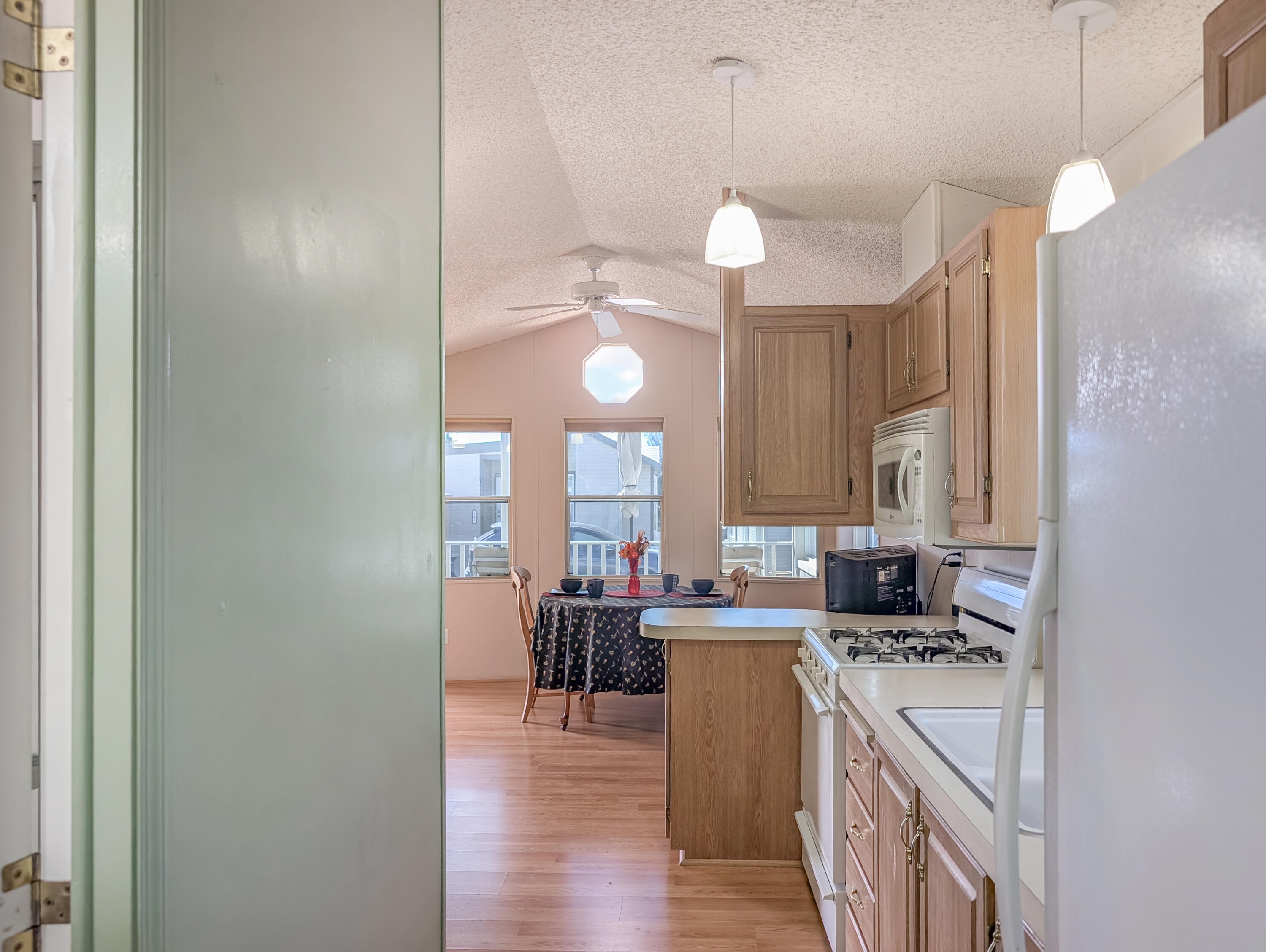 70200 Dillon Road, Unit 422 Desert Hot Springs, CA 92241 - Photo 23 of 25 a kitchen with a sink cabinets and wooden floor