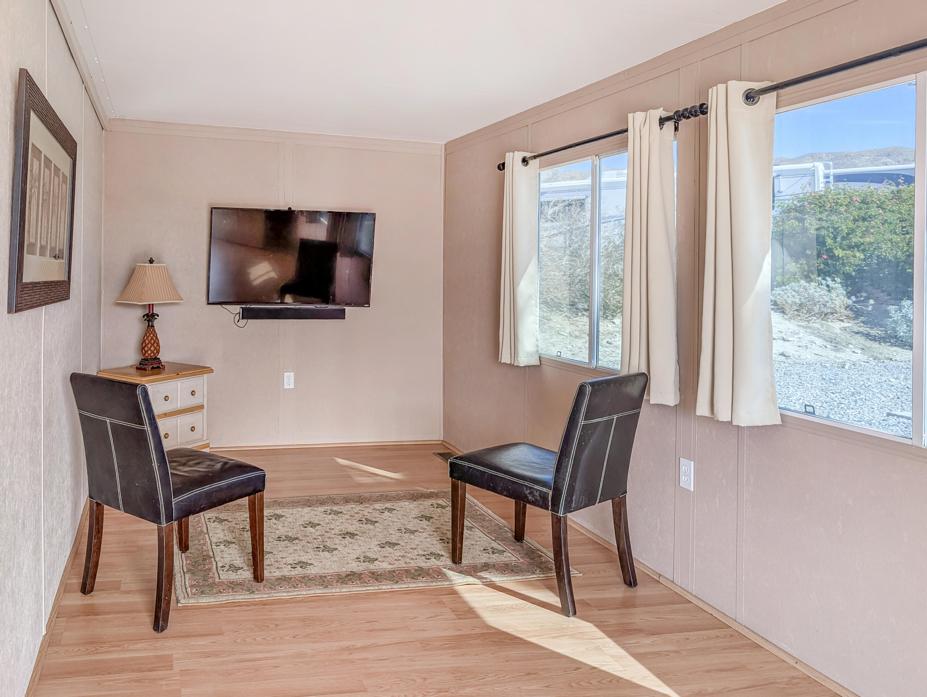 70200 Dillon Road, Unit 422 Desert Hot Springs, CA 92241 - Photo 8 of 25 a living room with furniture and a flat screen tv