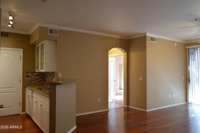 a kitchen with granite countertop a refrigerator and a stove top oven