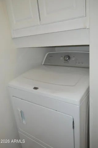 a view of a kitchen with wooden floor and a window