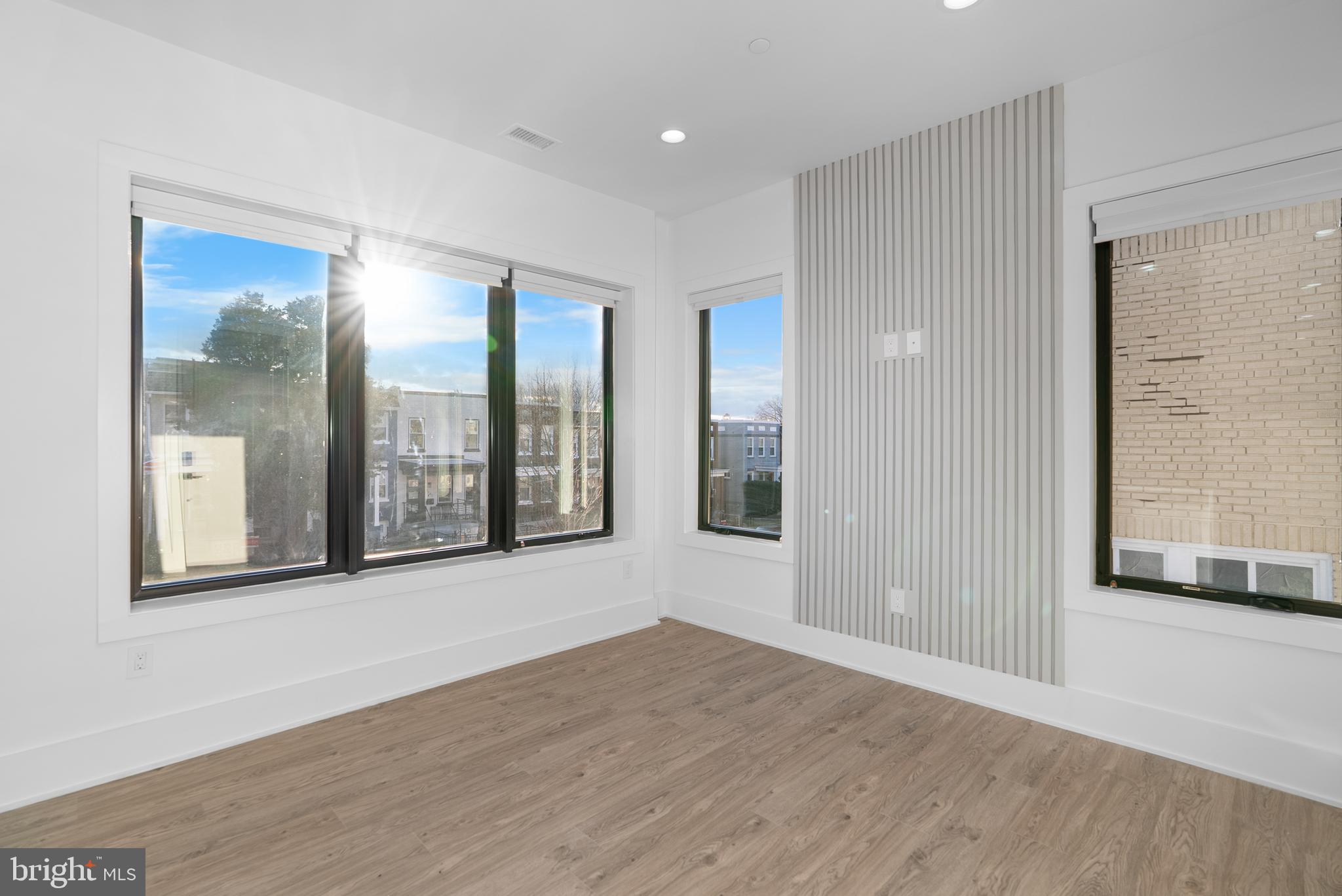 1140 Oates Street Northeast, Unit 202 Washington, DC 20002 - Photo 15 of 48 a view of an empty room with wooden floor and a window