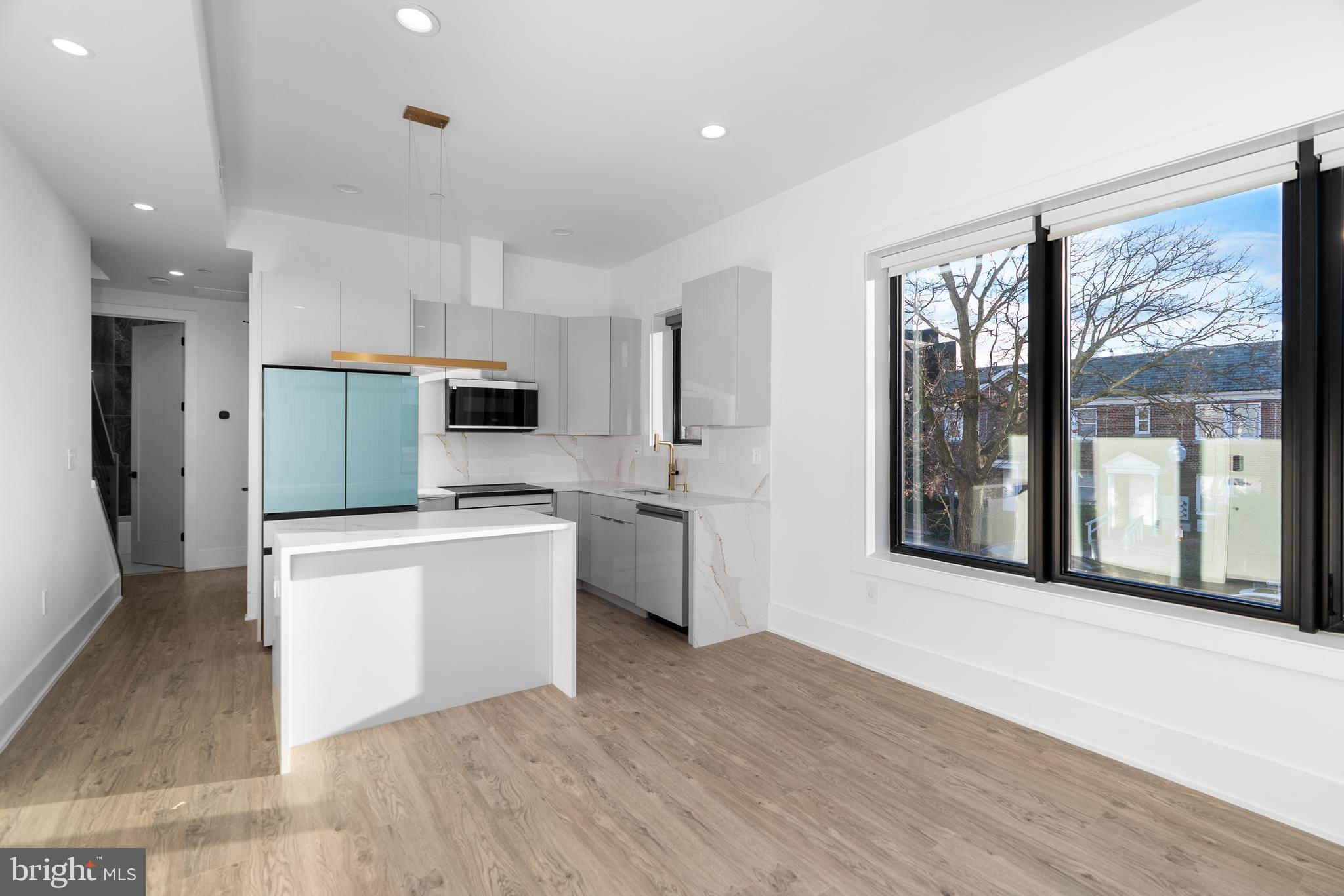 1140 Oates Street Northeast, Unit 202 Washington, DC 20002 - Photo 18 of 48 a kitchen with stainless steel appliances a refrigerator sink and cabinets