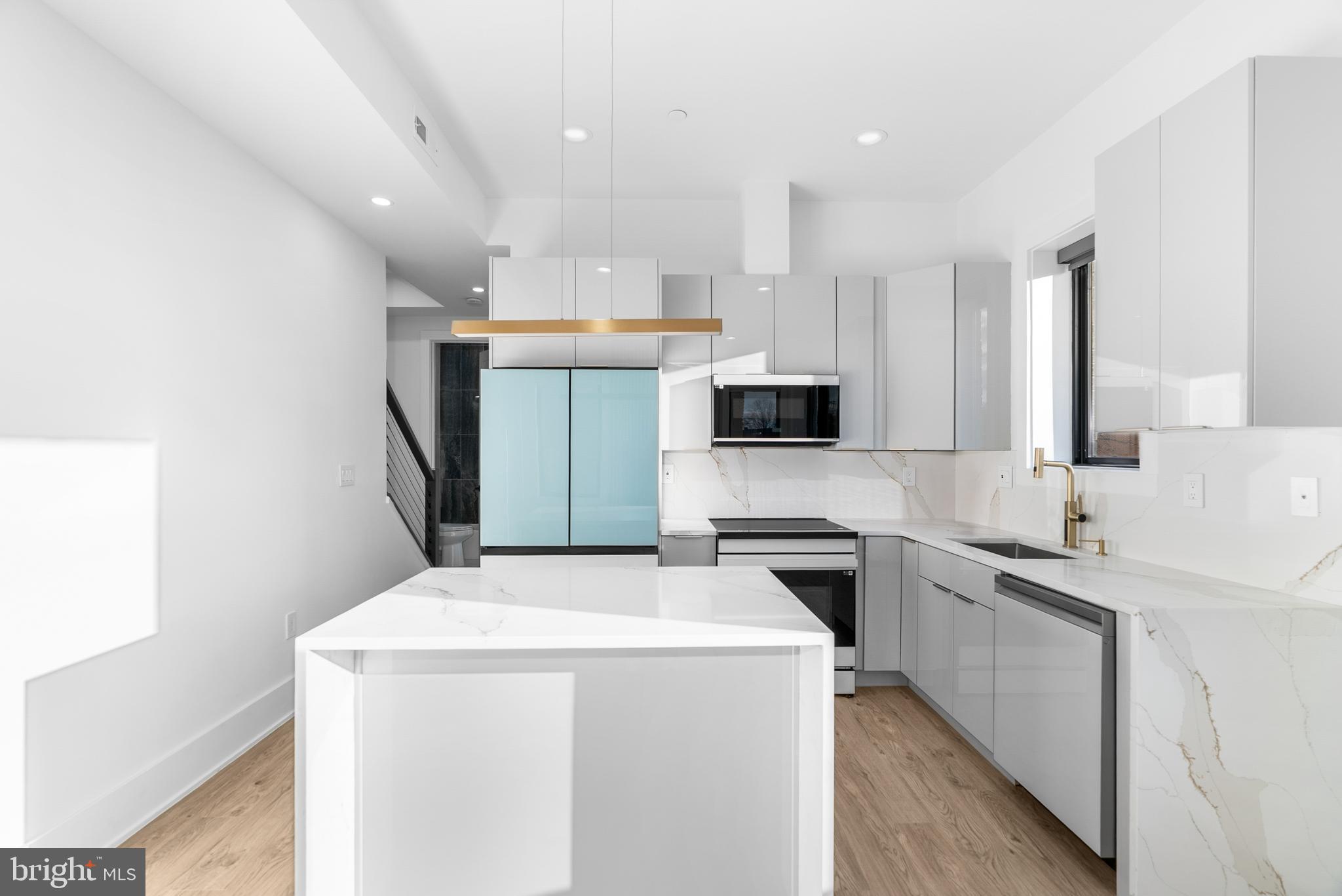 1140 Oates Street Northeast, Unit 202 Washington, DC 20002 - Photo 23 of 48 a kitchen with stainless steel appliances a refrigerator sink and microwave