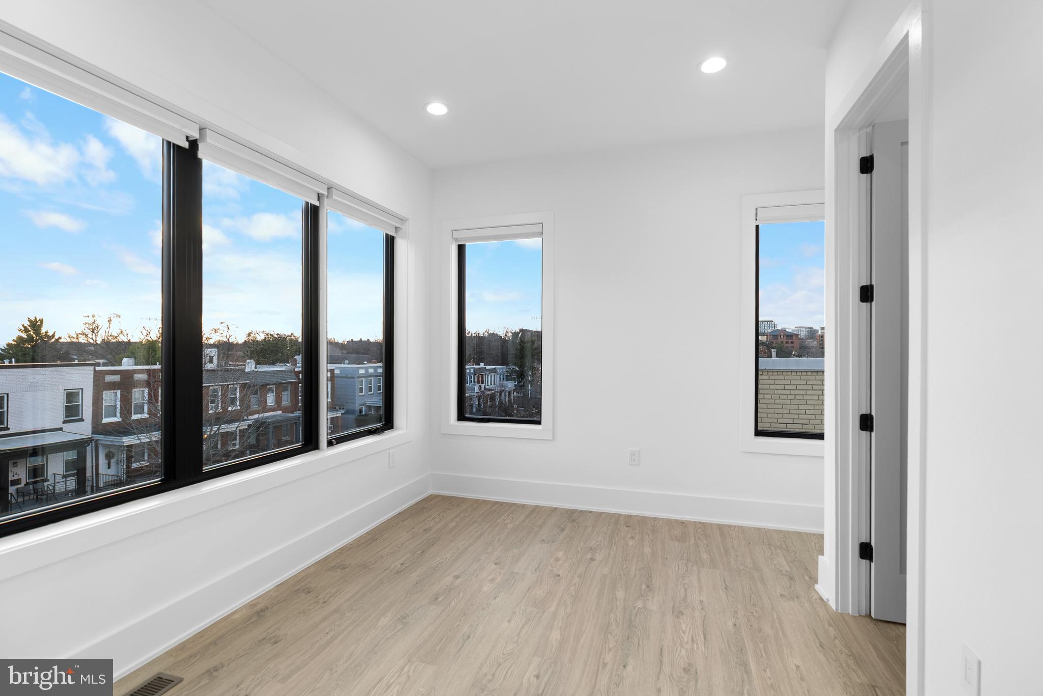 1140 Oates Street Northeast, Unit 202 Washington, DC 20002 - Photo 33 of 48 an empty room with wooden floor and windows