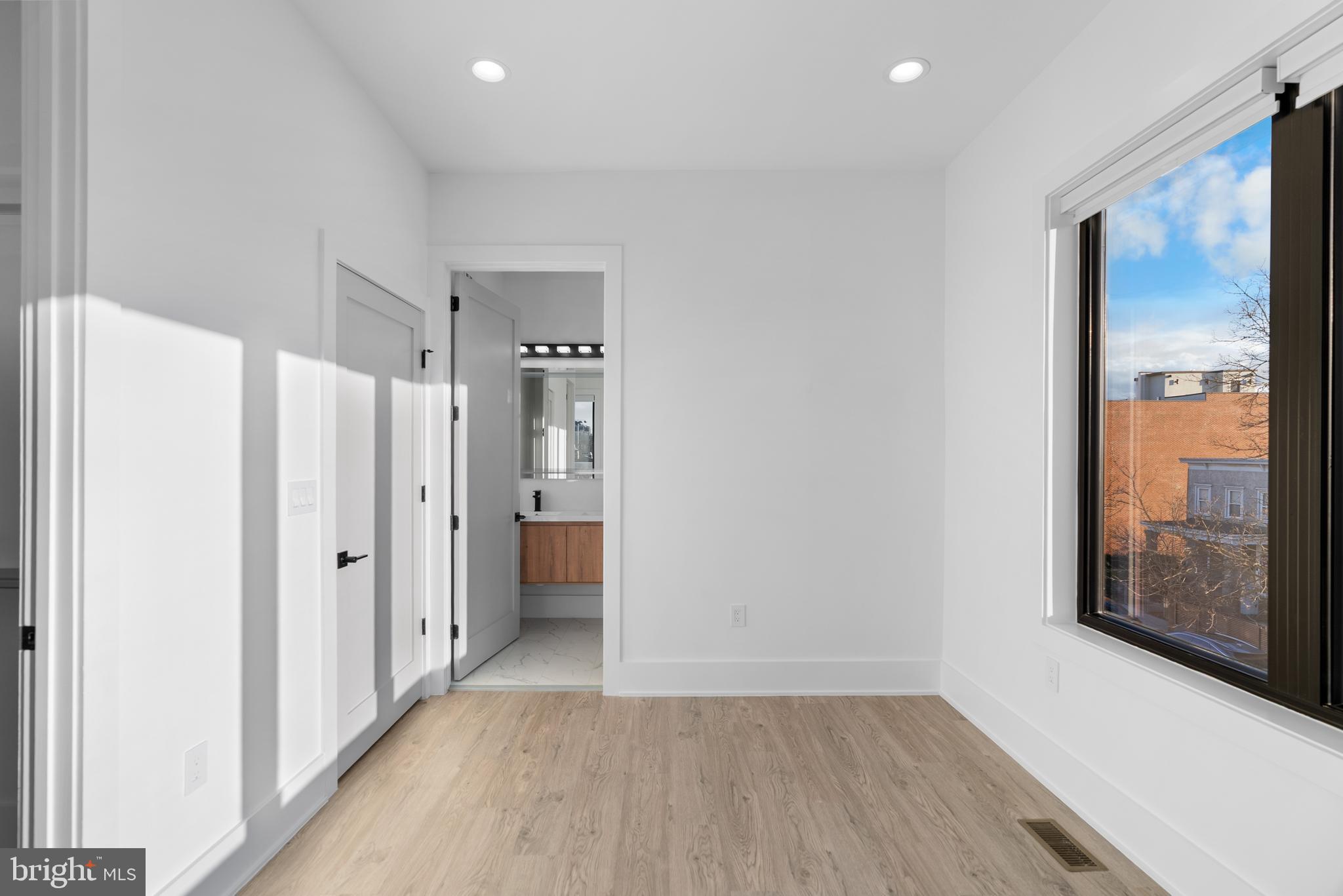 1140 Oates Street Northeast, Unit 202 Washington, DC 20002 - Photo 34 of 48 a view of a hallway with wooden floor and closet area