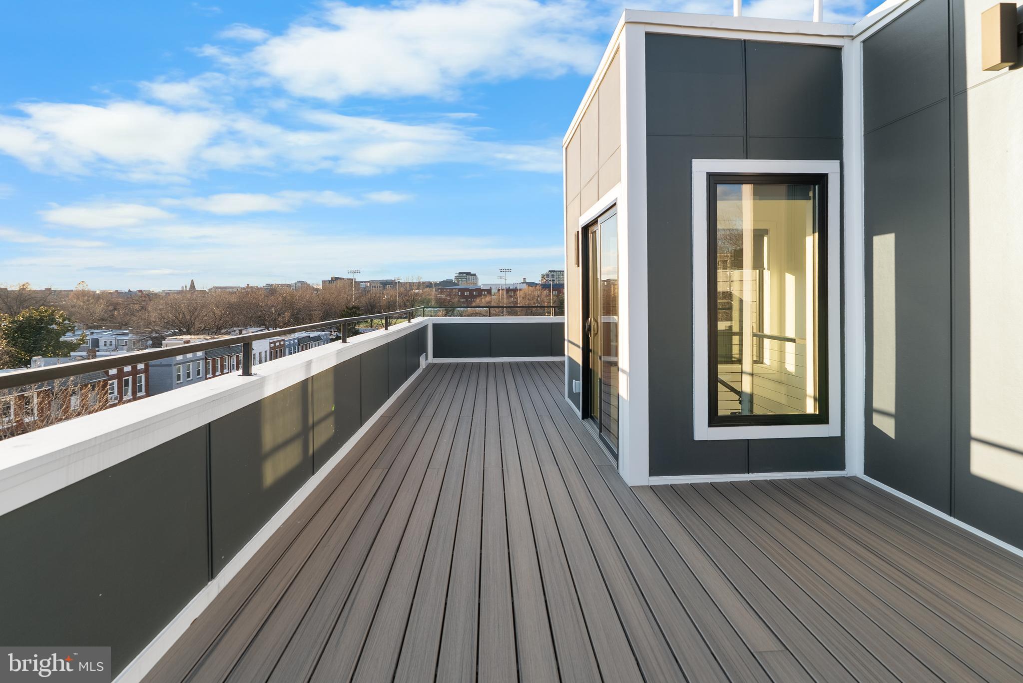 1140 Oates Street Northeast, Unit 202 Washington, DC 20002 - Photo 43 of 48 a view of outdoor space with wooden floor and city view