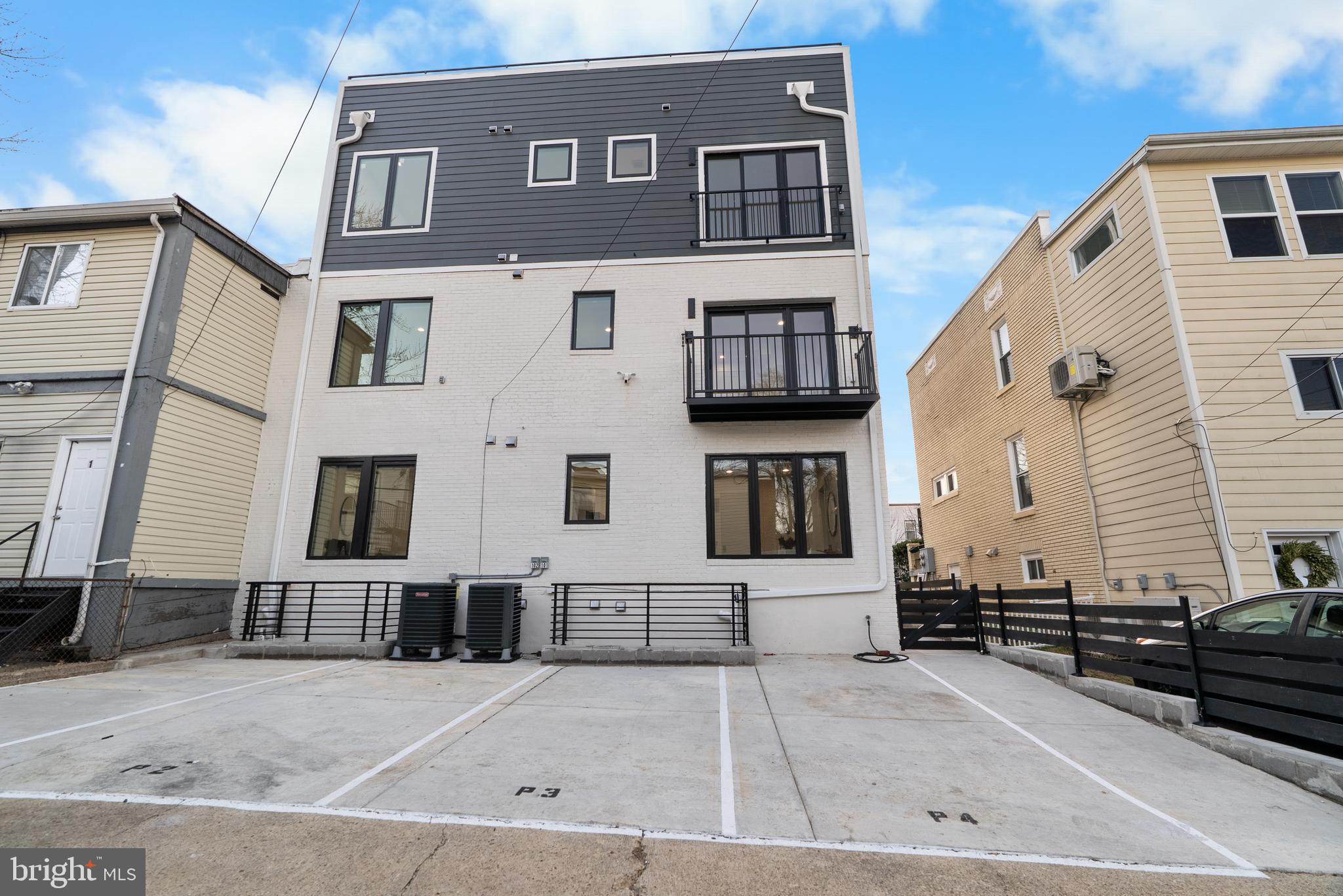 1140 Oates Street Northeast, Unit 202 Washington, DC 20002 - Photo 47 of 48 a front view of a house with a yard
