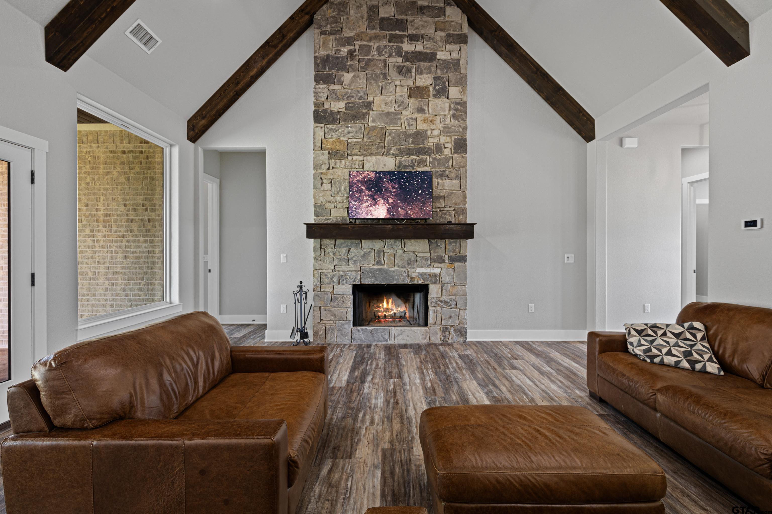 8947 Pomagranate Road Gilmer, TX 75645 - Photo 11 of 38 a living room with furniture and a fireplace