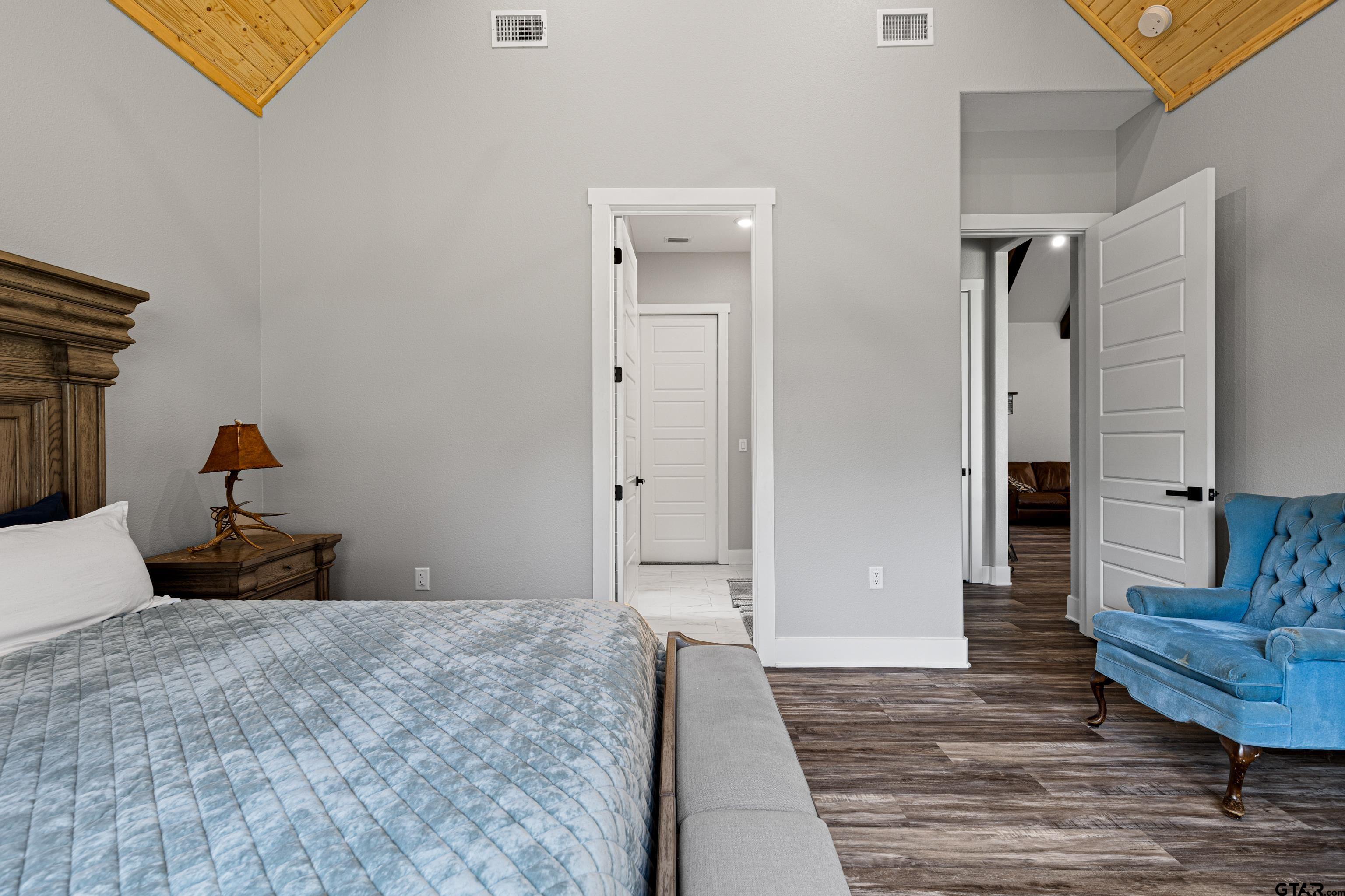 8947 Pomagranate Road Gilmer, TX 75645 - Photo 23 of 38 a bedroom with a bed and wooden floor