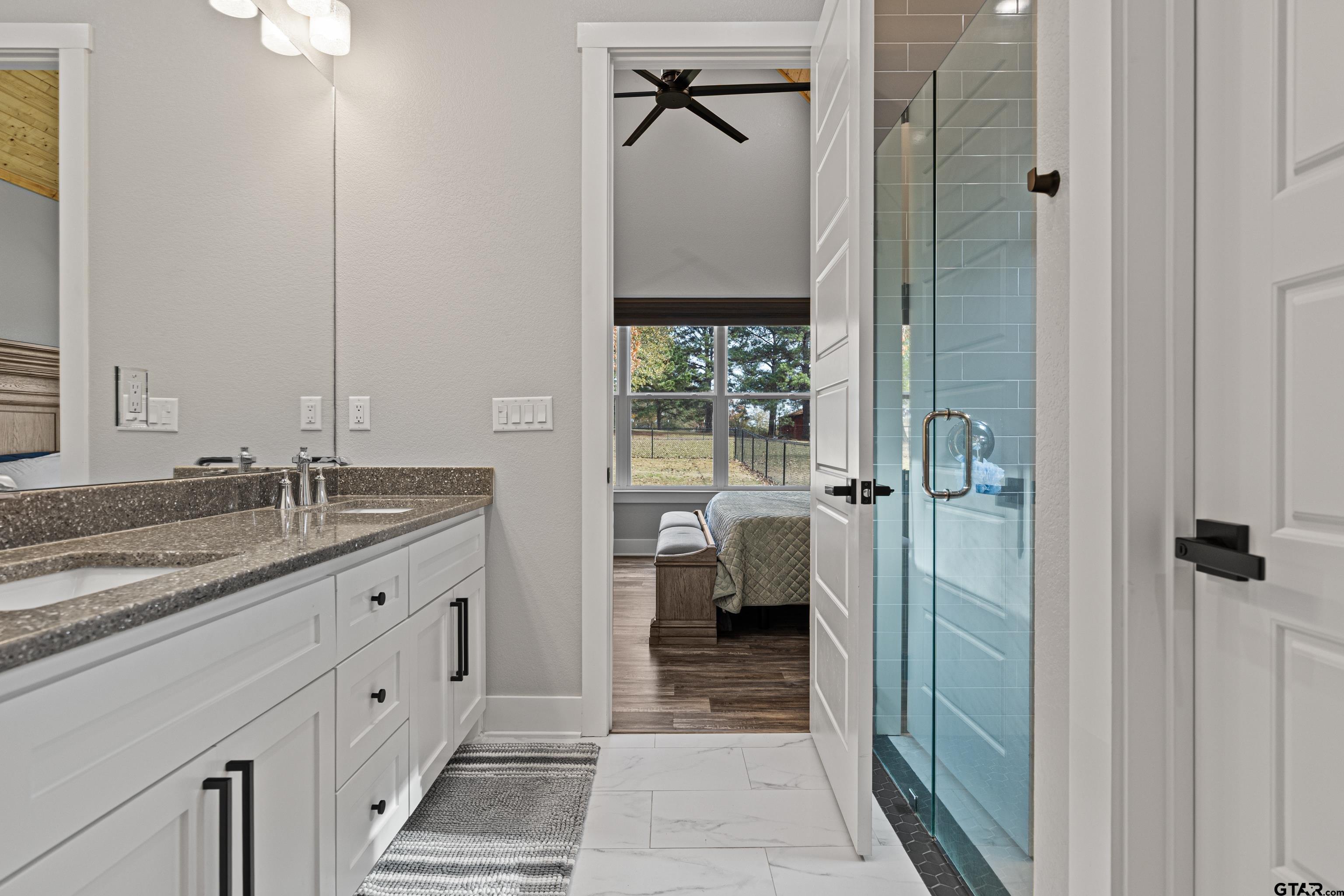 8947 Pomagranate Road Gilmer, TX 75645 - Photo 26 of 38 a spacious bathroom with a shower and a sink