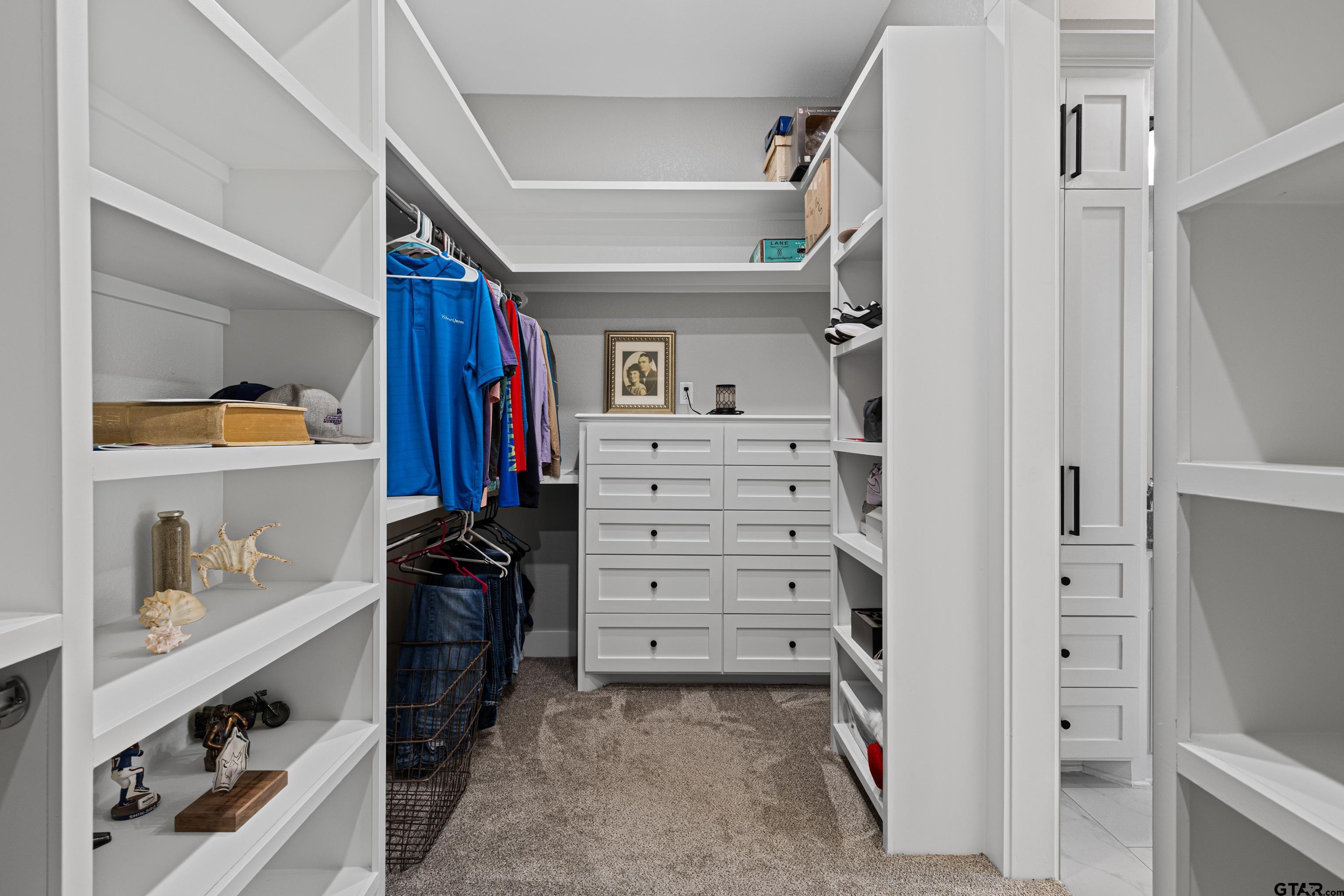 8947 Pomagranate Road Gilmer, TX 75645 - Photo 27 of 38 a view of walk in closet with clothes and shoes