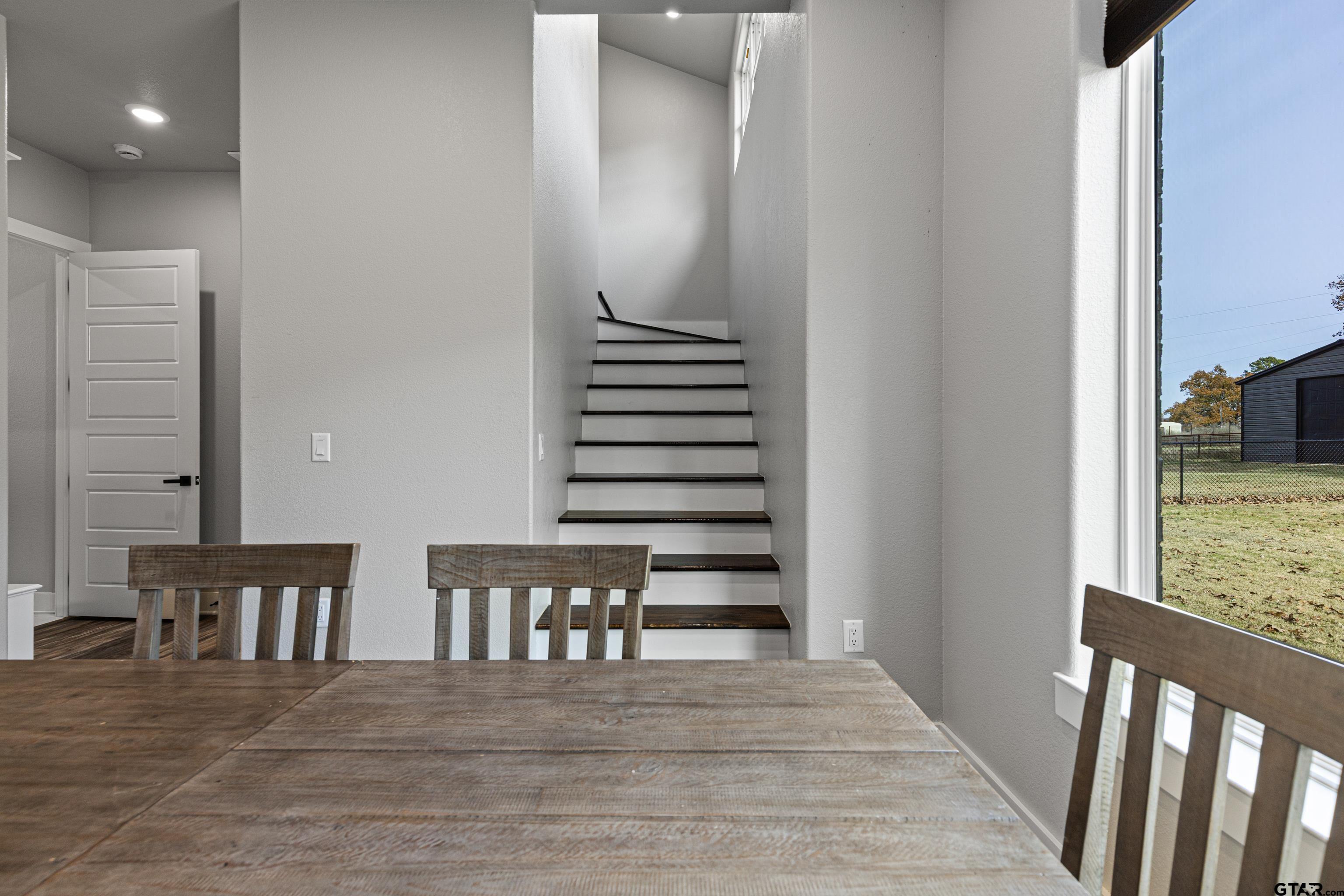 8947 Pomagranate Road Gilmer, TX 75645 - Photo 28 of 38 a view of a hallway with wooden floor and dining room