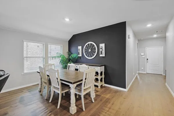 a view of a dining room with furniture and wooden floor
