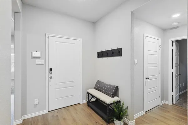 a view of a bedroom with furniture and wooden floor