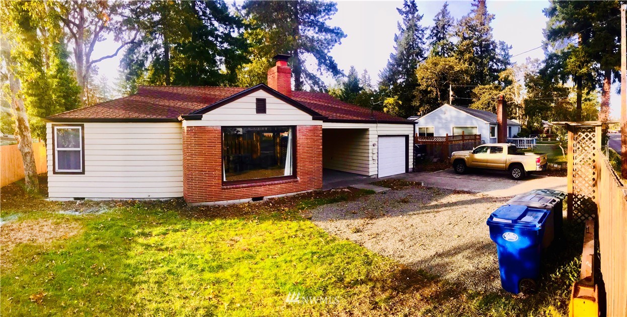 8410 Custer Road Southwest Lakewood, WA 98499 - Photo 1 of 16 a view of a house with backyard and sitting area