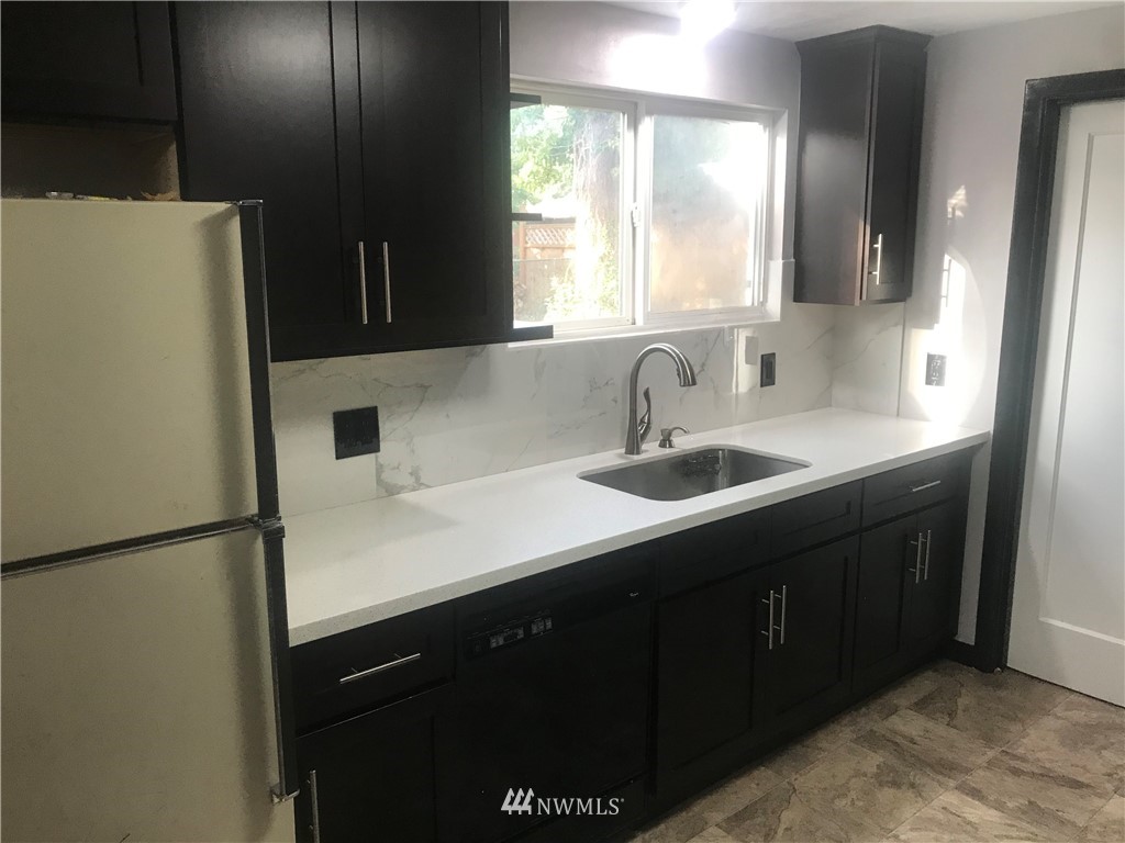 8410 Custer Road Southwest Lakewood, WA 98499 - Photo 13 of 16 a kitchen with a sink and a refrigerator