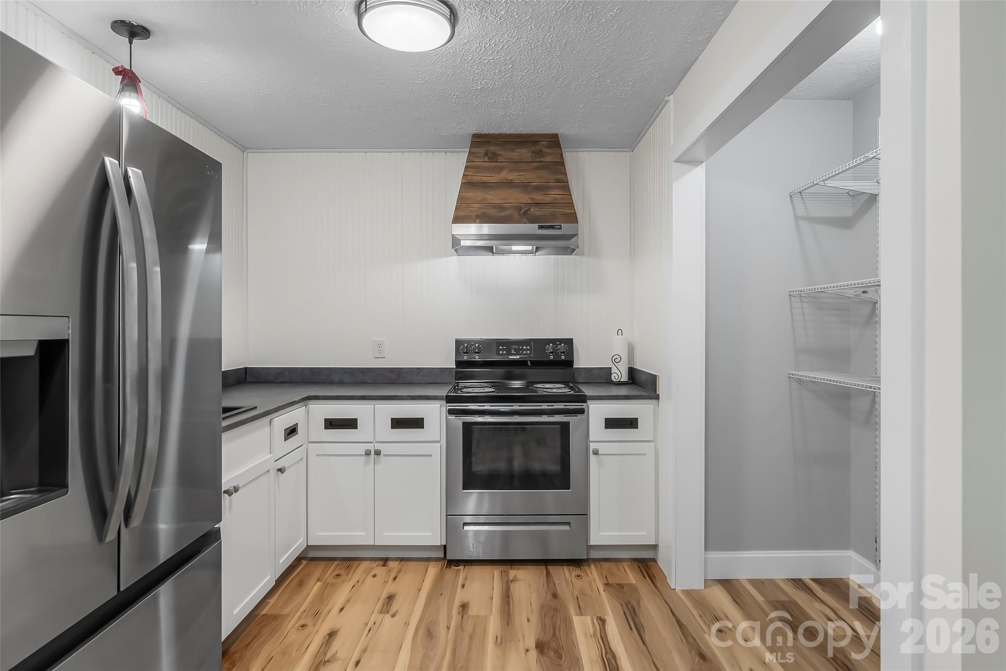 825 South Creek Road Nebo, NC 28761 - Photo 14 of 34 a kitchen with a stove and a refrigerator