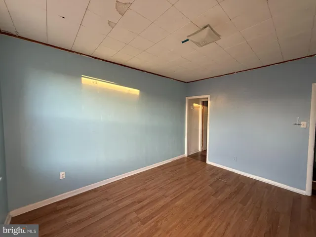 a view of a room with wooden floor