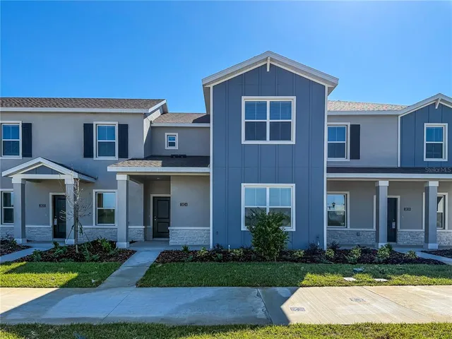 a front view of a house with yard and green space
