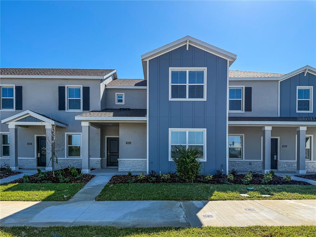 a front view of a house with yard and green space
