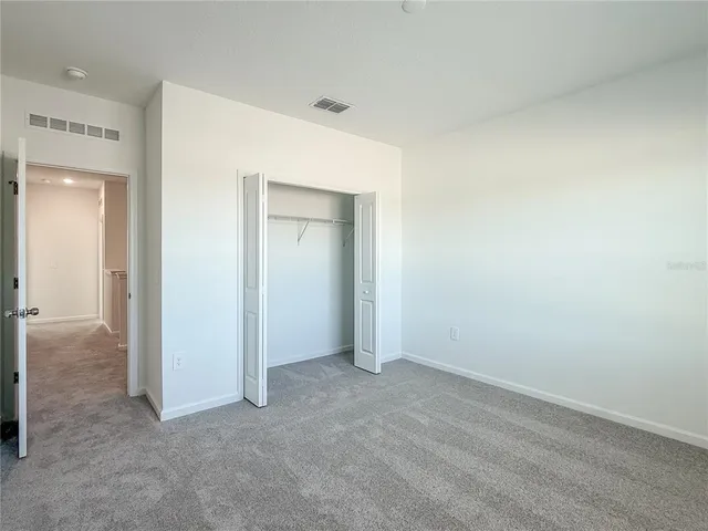 an empty room with closet area