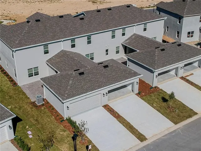 an aerial view of residential house with outdoor space and swimming pool