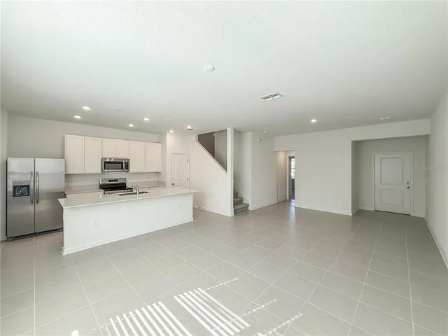 a view of kitchen with kitchen island microwave and stove