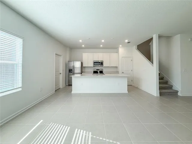 a view of a kitchen with furniture and a window