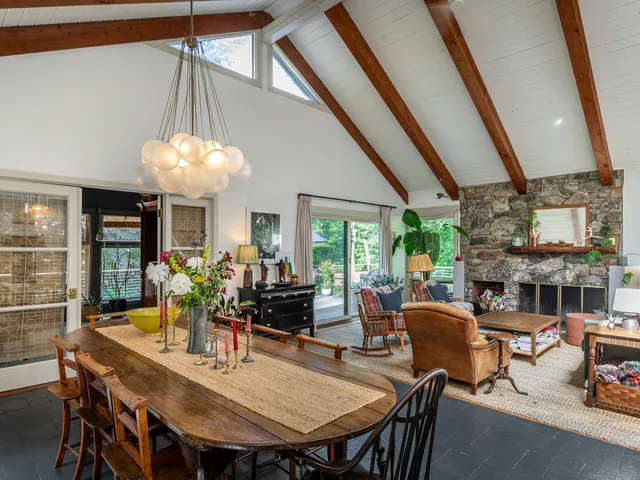 a kitchen with granite countertop a table chairs sink and cabinets