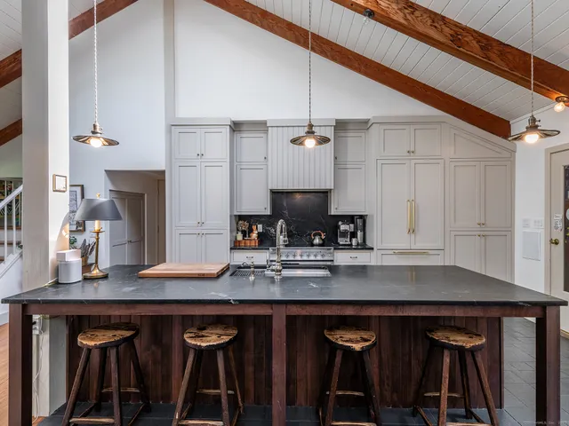 a dining room with furniture and a kitchen view