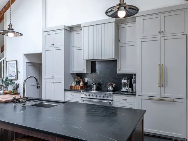 a living room with furniture fireplace and a large window