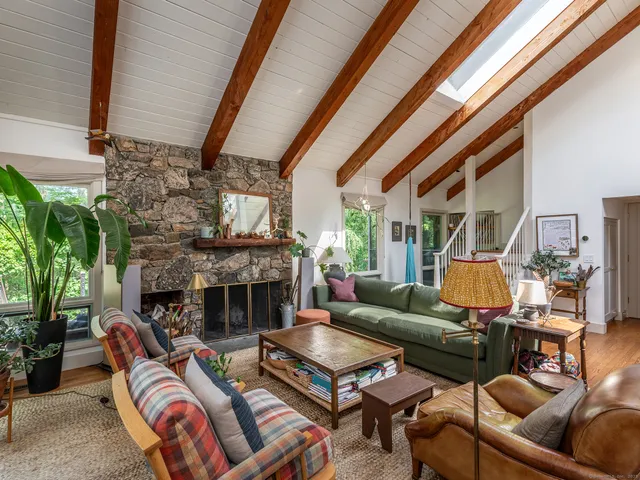 a living room with furniture and floor to ceiling windows