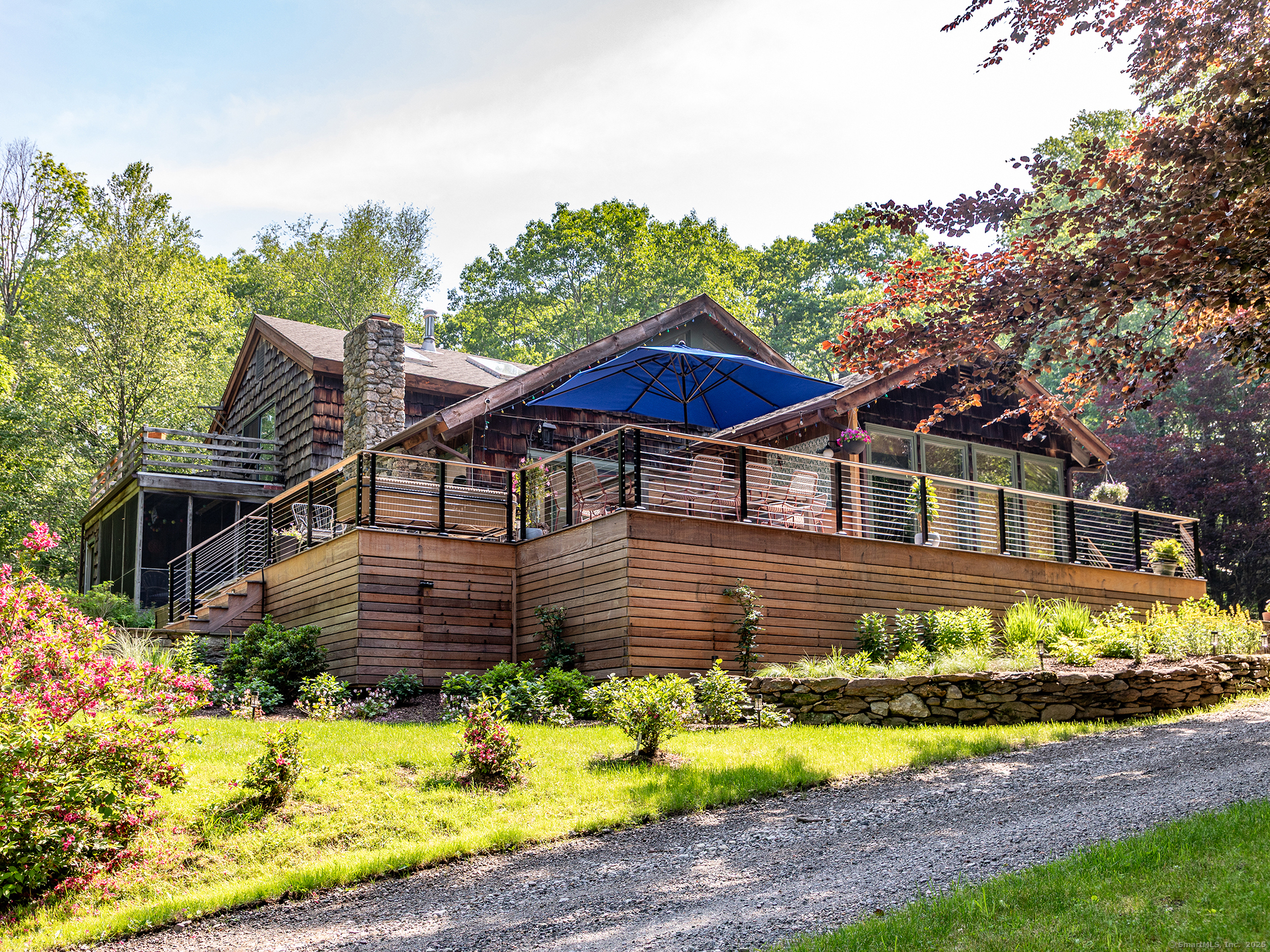 203 Brick School Road Warren, CT 06754 - Photo 2 of 40 a front view of a house with a garden and swimming pool