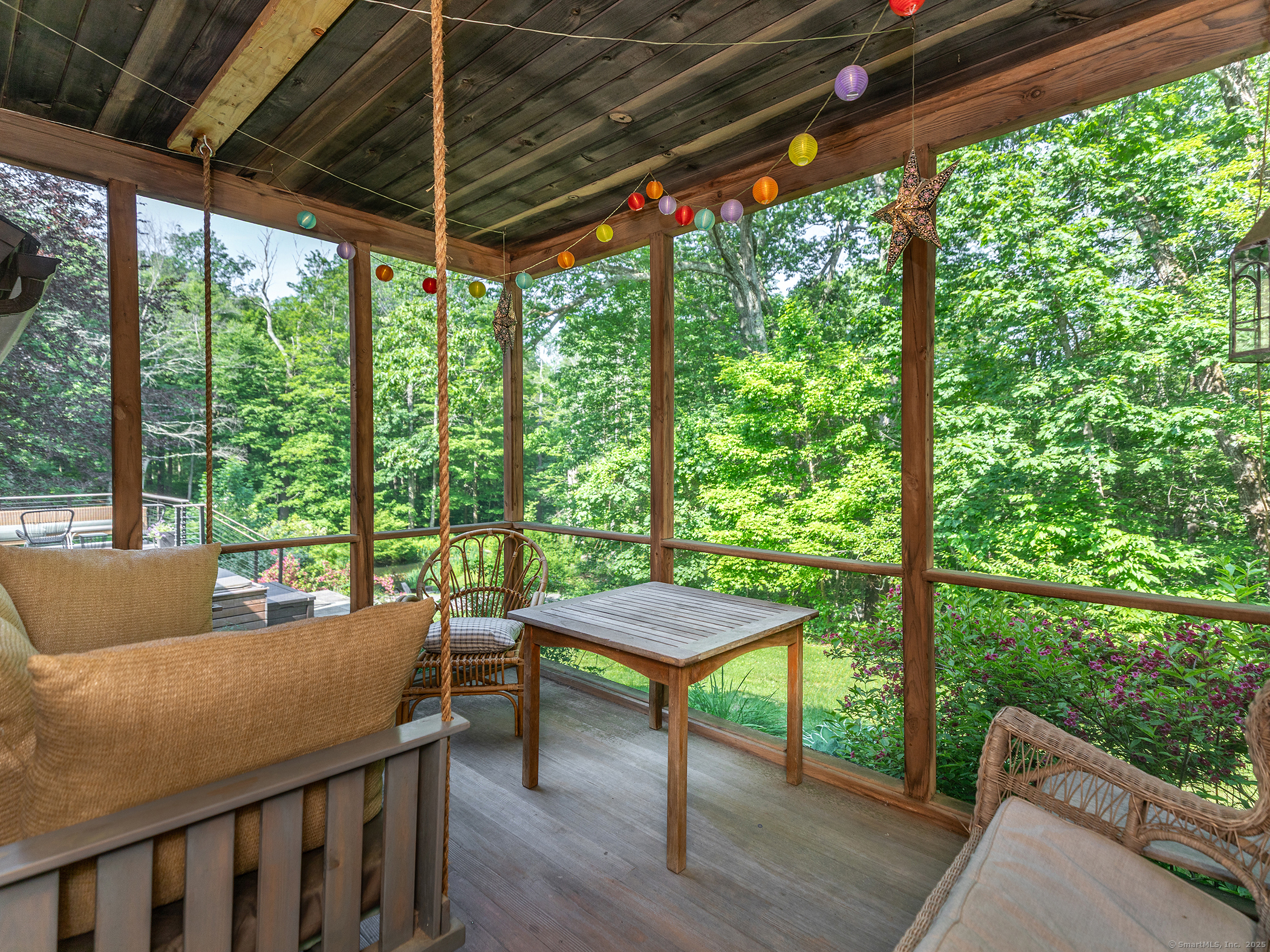 203 Brick School Road Warren, CT 06754 - Photo 25 of 40 a view of a porch with furniture and a backyard