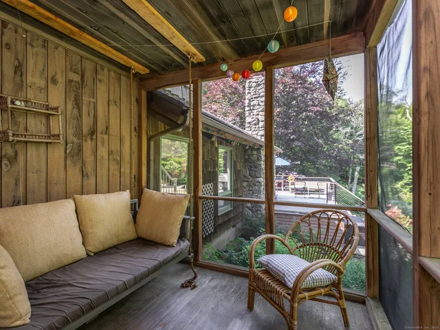 a living room with furniture and a book shelf